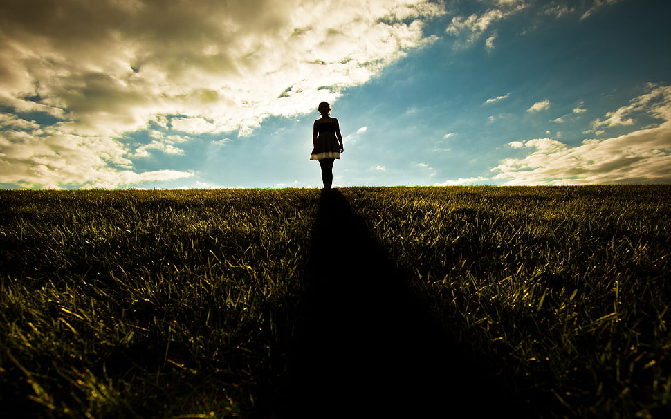woman standing on grass field screenshot HD wallpaper