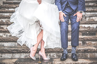bride and groom standing on brown concrete steps