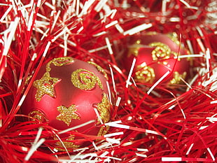 red-and-gold christmas baubles in shallow photographyt