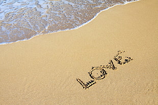 Love written on white sand HD wallpaper