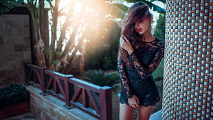 woman wearing black lace long-sleeved rompers