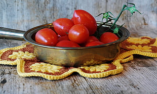 red tomatoes in stainless steel soup pan