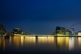 city buildings and body of water during night time, copenhagen