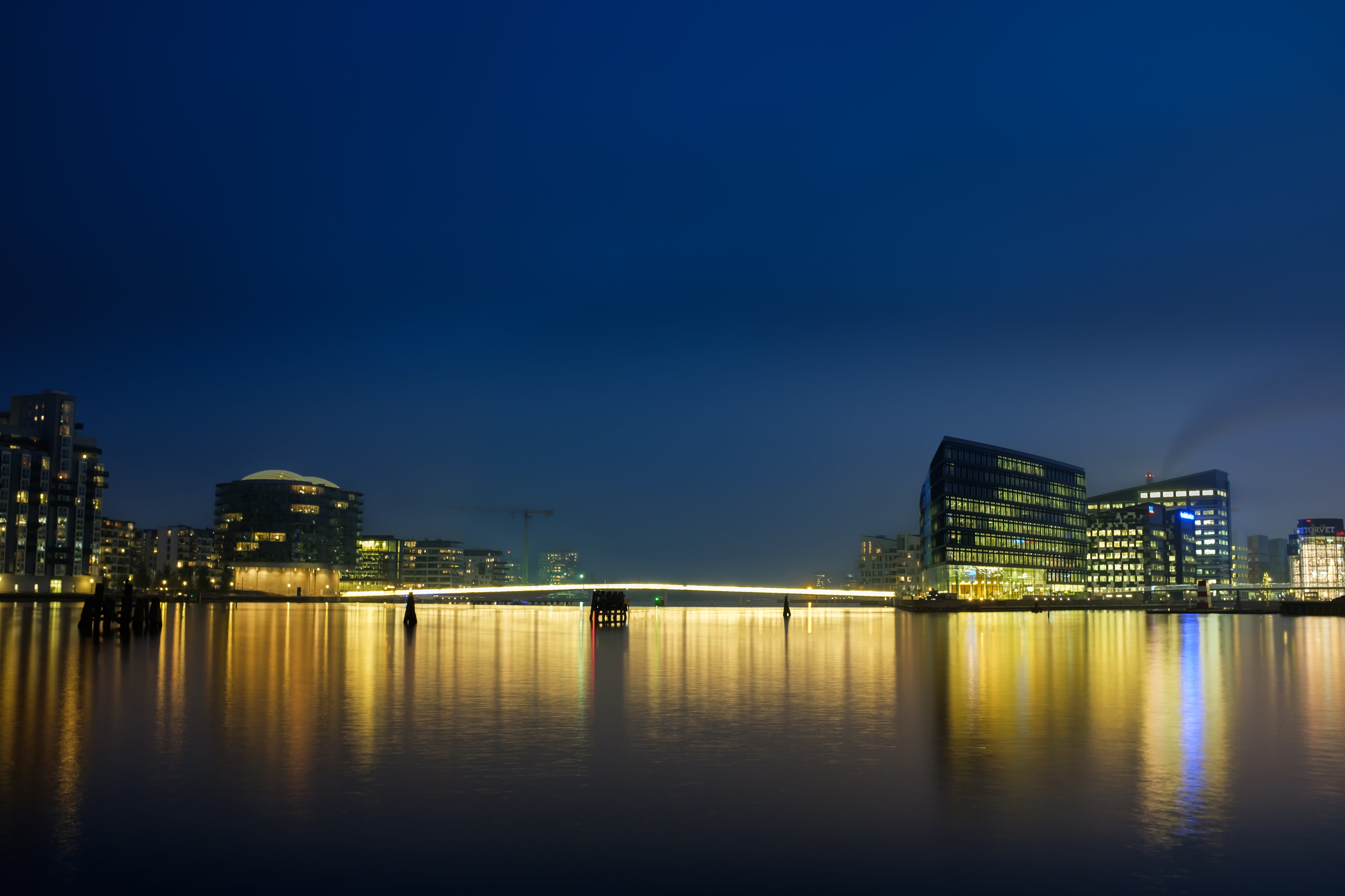city buildings and body of water during night time, copenhagen