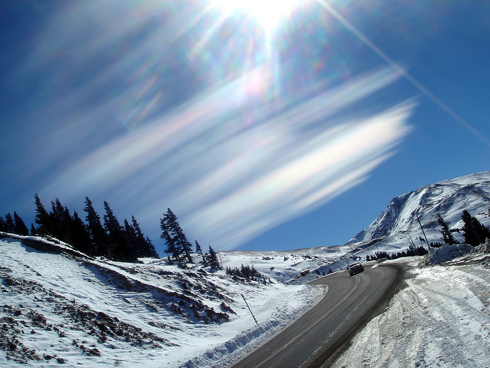 snow on mountaintops under blue sky HD wallpaper