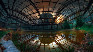 360 photo of still water inside black framed glass roofed building during golden hour