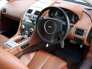black Aston Martin car steering wheel and center stack