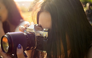 woman holding Canon power-shot taking photo HD wallpaper