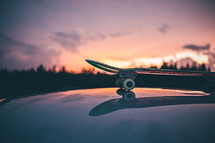 skateboard on glass water surface during dawn