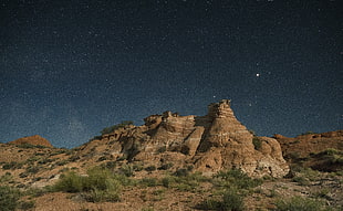 brown rock formation during nighttime HD wallpaper