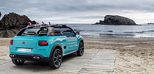 blue Citroen C4 Cactus parked in front body of water at daytime
