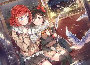 two female character sitting inside train