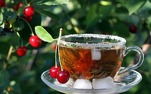 red cherries with clear glass cup