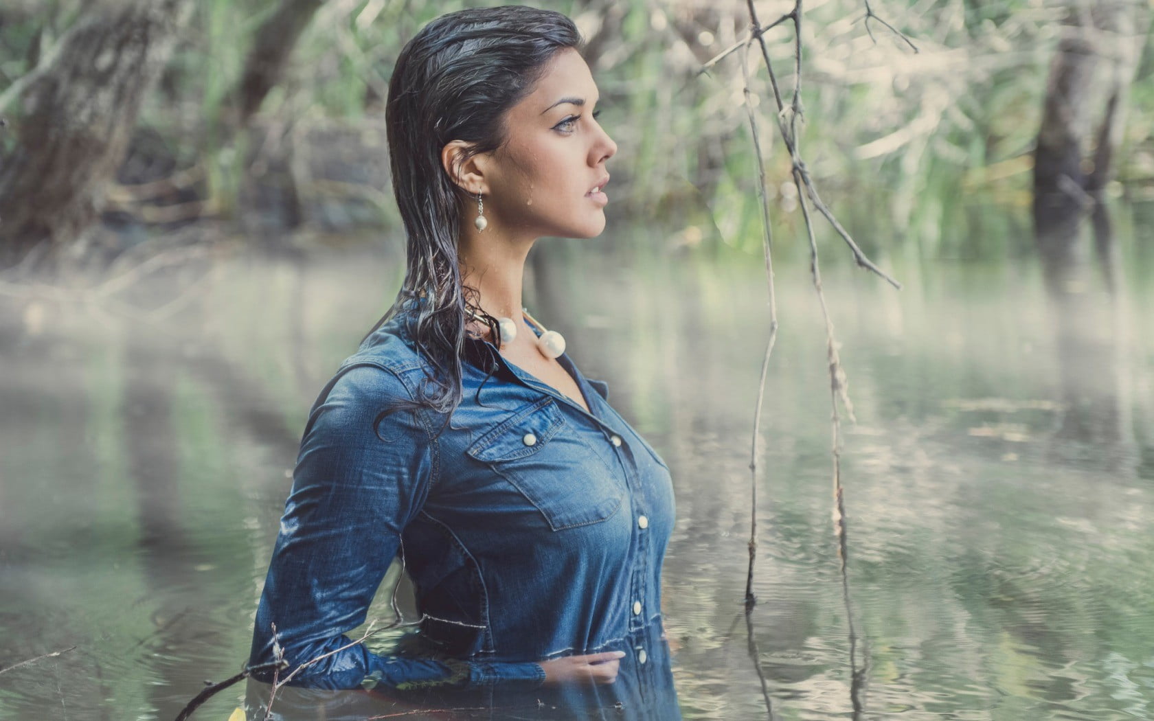 Woman walking on lagoon wearing blue chambray button-up dres