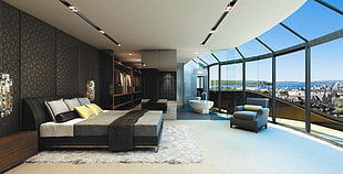 black wooden bed frame with beddings near gray leather sofa chair inside room