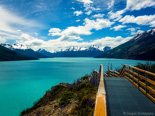 photo of bridge and sea surrounded by mountains during daytime HD wallpaper