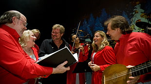 group of people playing musical instrument smiling