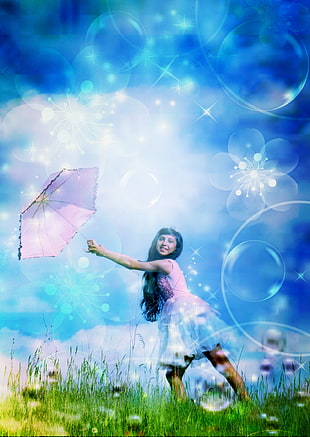 girl with a pink umbrella on a flower garden photo