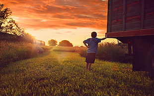 boy's blue t-shirt and black shorts, sunset