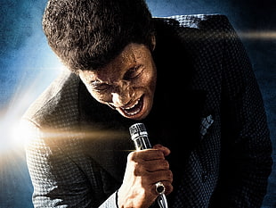 man in black top holding microphone digital wallpaper