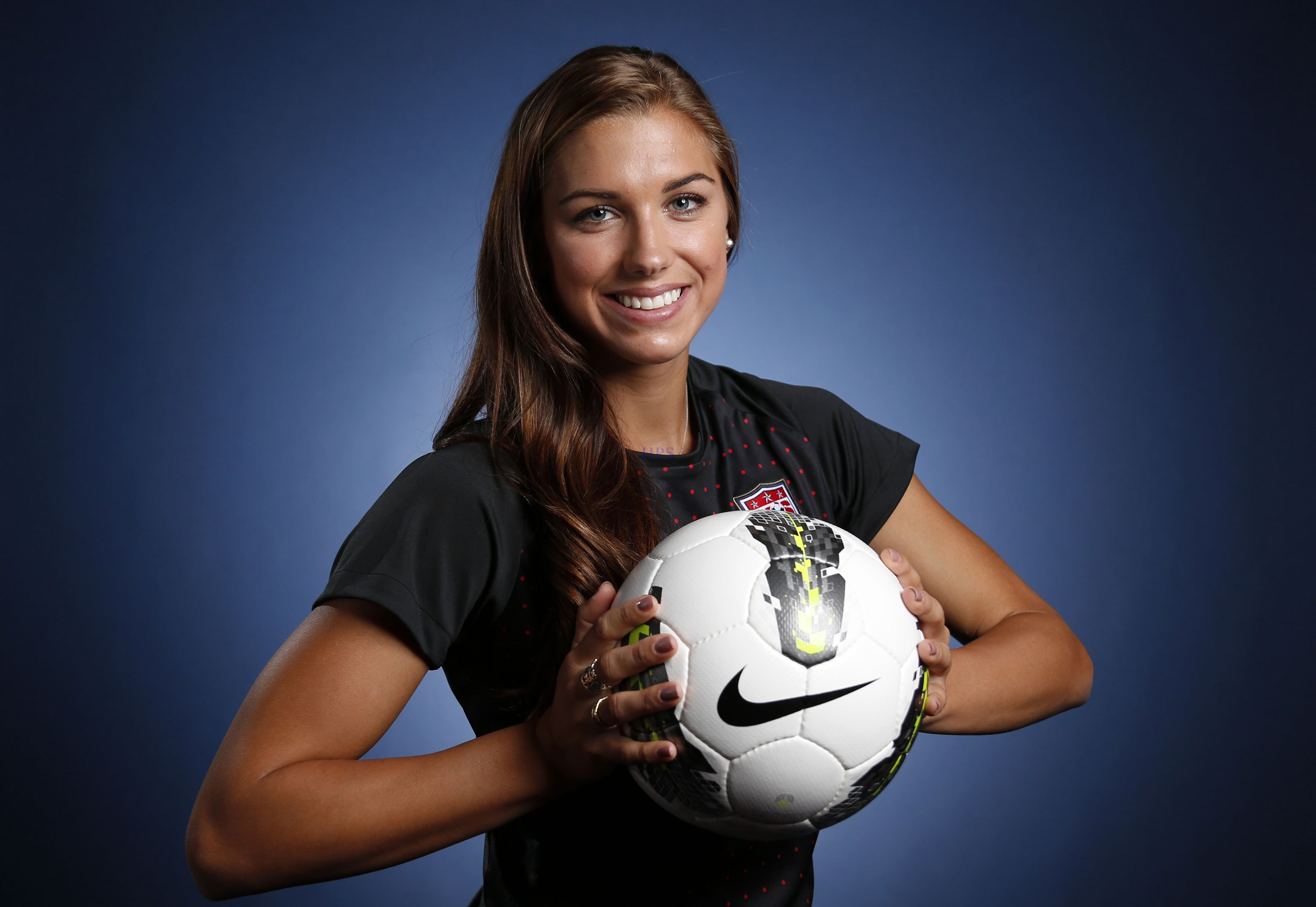 woman holding white and black Nike volleyball