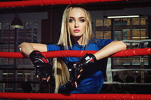 woman wearing blue crew-neck shirt and black grappling gloves