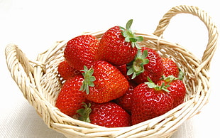 strawberry fruits on beige wicker basket