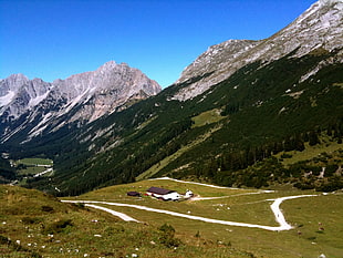 grass covered fault-block mountains near white house during daytime, tirol, scharnitz, achensee, austria