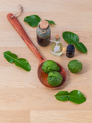 green fruits on brown wooden saptula