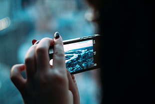 person watching video on smartphone