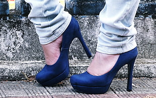 woman wearing pair of blue pumps