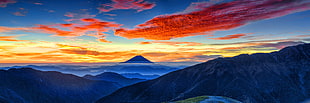 blue mountains with orange clouds and blue sky landscape photo
