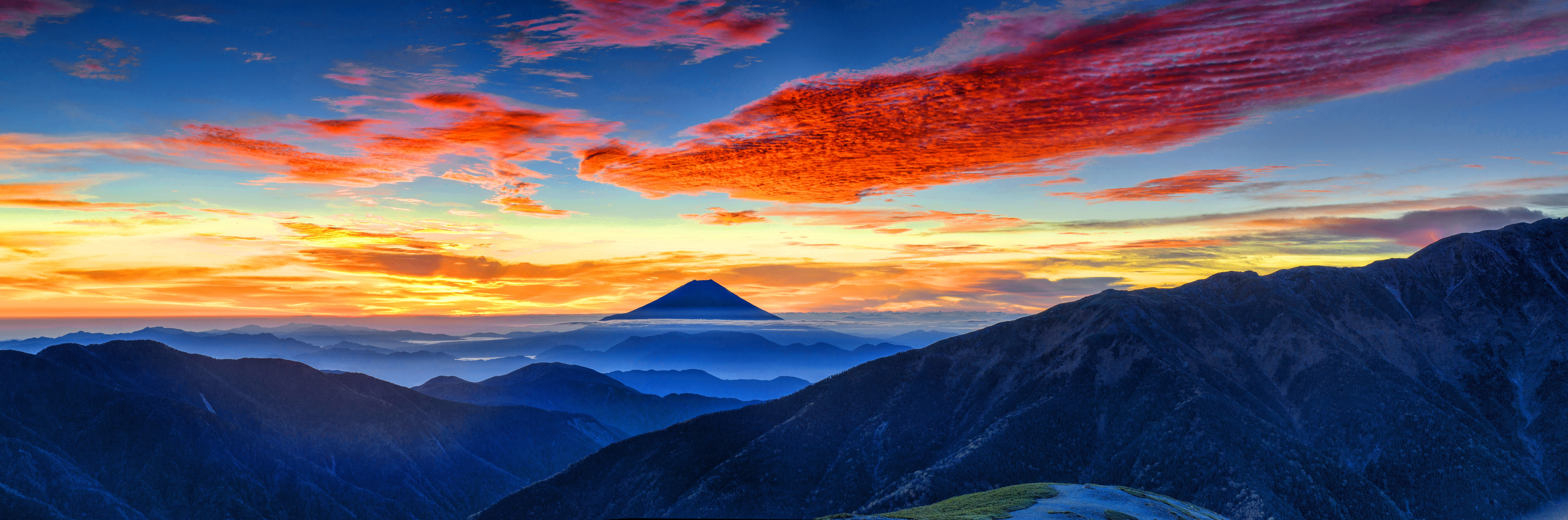Blue mountains with orange clouds and blue sky landscape  