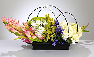 assorted flowers in black metal basket
