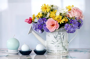 colored flowers on white flower vas