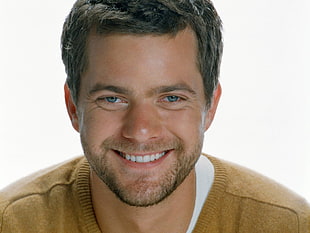 man wearing brown shirt smiling photo