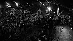 grayscale photography of band playing on stage in front of crowd