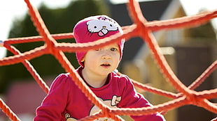 photography of toddler wearing pink beanie