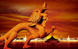 photograph of brown dragon concrete statue