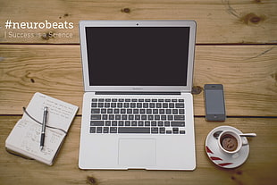 MacBook Air between pen and coffee