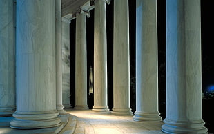white concrete column pillars with lights during nighttime