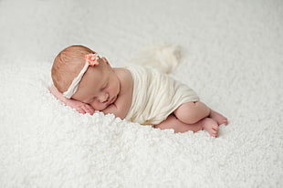 baby wrapped in white blanket while sleeping HD wallpaper