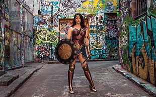 Wonder Woman costume beside painting wall HD wallpaper
