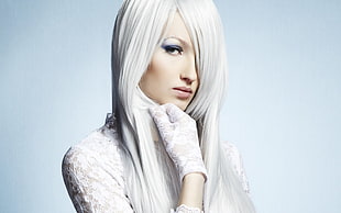 woman with white hair wearing white lace top and lace gloves