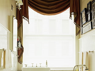 white painted hall with brown fringe-trim valance