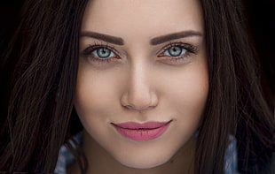 woman wearing contact lens and pink lipstick