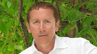 man in white button-up dress shirt standing near green leaf tree HD wallpaper