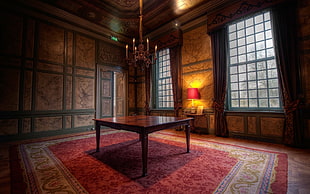 photography of brown wooden table on red and gray floor rug