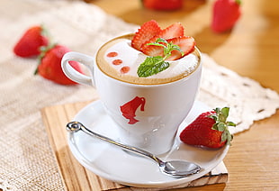 white ceramic cup with coffee and strawberries