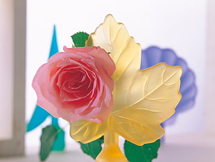 red and yellow plastic petaled flower